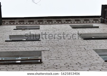 Gray brick building with Windows.