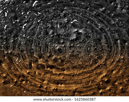 The​ water​ on the black​ pattern​ background. The bubbles​ of water​ drop​ on dark​ background​