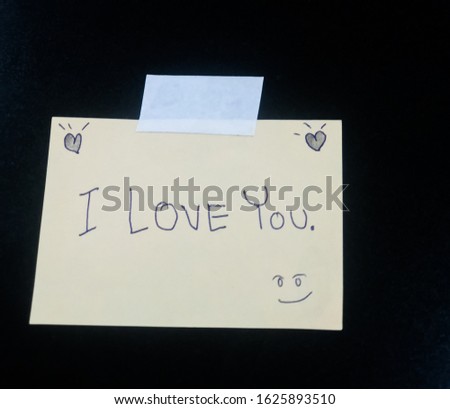 The message on a small piece of paper says that I love you. And black background