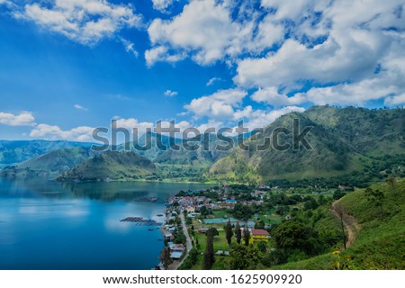 grainy and noisy photo of volcano Lake Toba (Danau Toba) or Toba Lake in the morning . one of the biggest lake in the world , located in North Sumatera, Indonesia Royalty-Free Stock Photo #1625909920