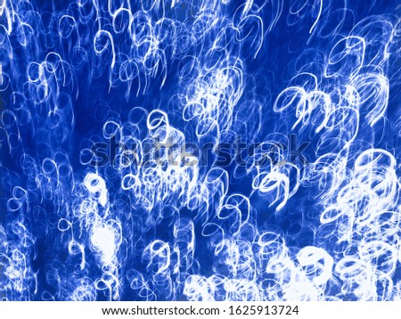 Abstraction of many numbers nine on classic phantom blue color made on long exposure abstract photo.