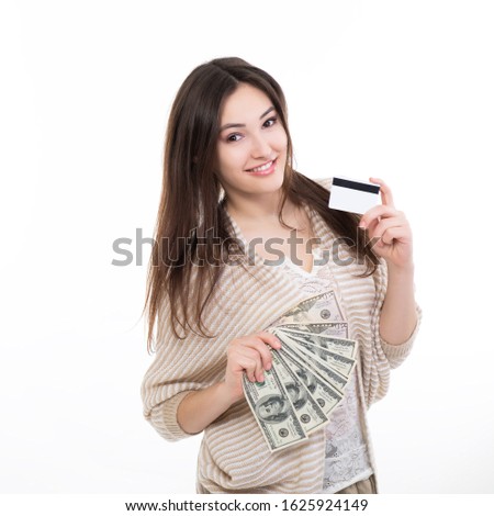 Cheerful happy smiling attractive young woman holding cash and plastic card, isolated on white background. Freelance, remote earnings, internet shopping concept