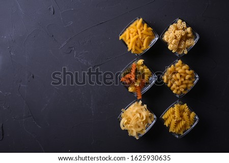 Various pasta. Cooking concept. Top view on dark beton background wuth a copy space.