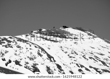 Italy, Sicily, Catania Province, man taking pictures on the volcano Etna with snow