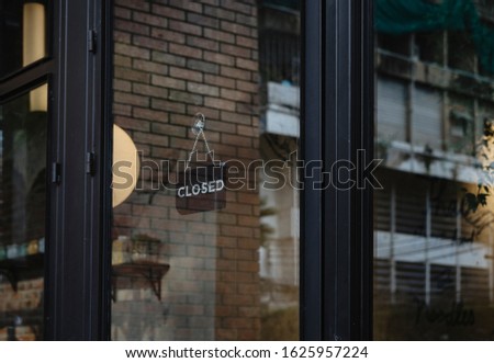  closed sign hanging outside a restaurant, store, office or other