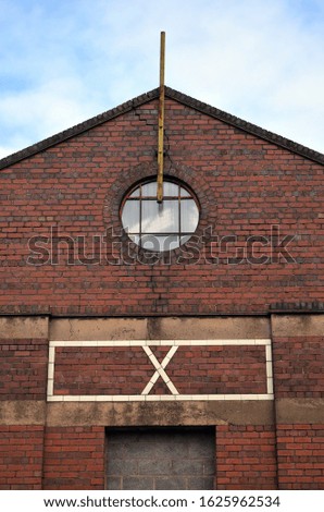 Glazed White Brick Sign on Side of Factory Building 