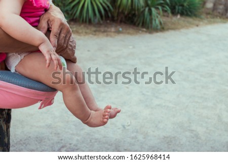 human baby toddler feet on parent hands with copy space
