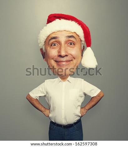 funny smiley senior man in red santa hat over grey background