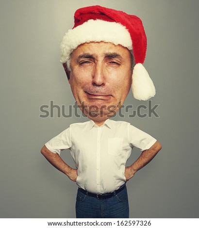 funny picture of unhappy senior man in red santa hat
