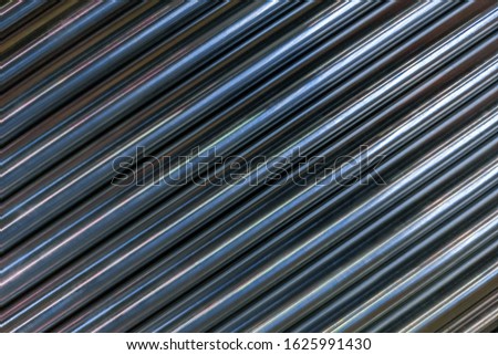 abstract industrial background of shiny cnc turned rods with flat lay diagonal geometric composition