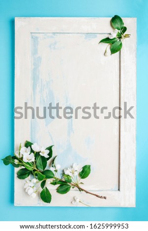 Spring concept backdrop. Romantic floral background. Abstract spring background, minimal composition. Apple tree branch on a wooden background in retro style.