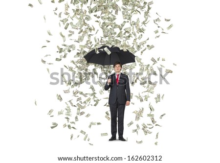 Businessman standing in the rain of dollars over white background