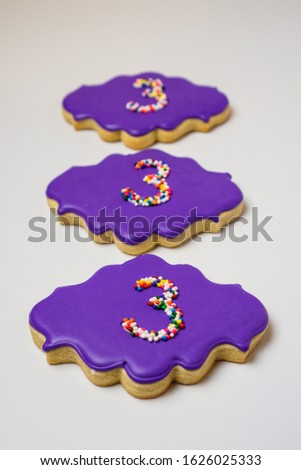 Number “3” cookie in purple.