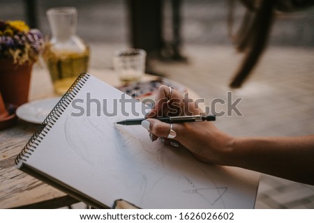 Street portrait artist sketch a picture on the street Royalty-Free Stock Photo #1626026602