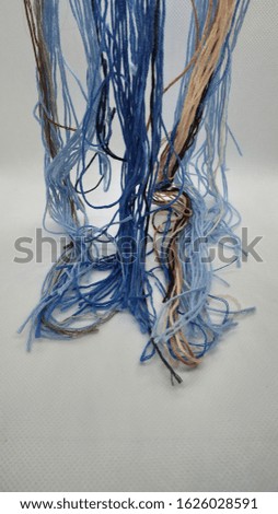 Sew with threads of different colors Royalty-Free Stock Photo #1626028591