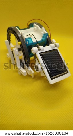 Robot assembled from parts on a solar panel Royalty-Free Stock Photo #1626030184