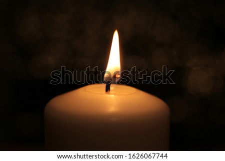  flame white round candle burns background fire