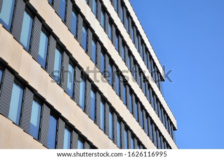 A view at a straight facade of a modern building with a dark grey facade. Dark grey metallic panel facad. Modern architectural details. 