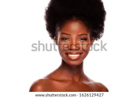 African Beauty Woman with Afro. A Young African American Model With Healthy Skin and Long Eyelashes is Happy Smiling and Looking at Front. Black Model isolated on a White Background in Beauty Concept.