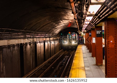 New York Subway Train Pulling in to station Royalty-Free Stock Photo #1626135952