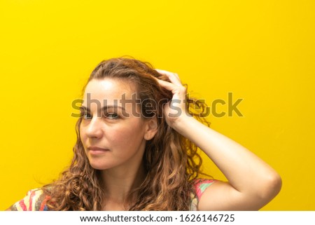 Photos of a beautiful blonde, young caucasian caucasian woman in a photo shoot performed on yellow background. Brazilian female beauty.