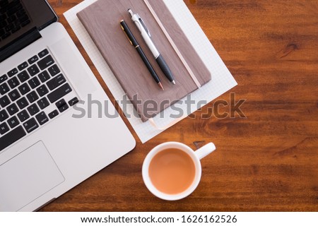 Hipster lifestyle. Working from home or at cafe or at the office. Computer, mobile device, smartphone, notebook, coffee and pens. Work anywhere. Working hard as an entrepreneur, small business  Royalty-Free Stock Photo #1626162526