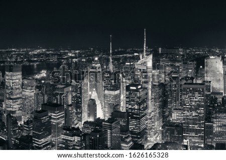 New York City midtown skyline with skyscrapers and urban cityscape at night.