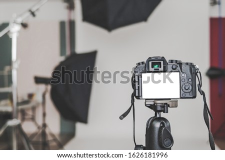 Mock up of a professional camera, in a photo studio, against the background of softbox light sources