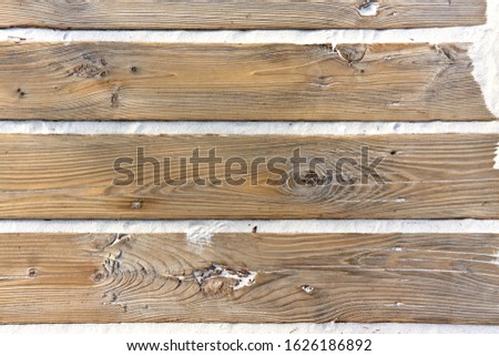 Wooden boardwalk planks with sand between them
