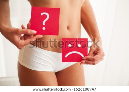 Health. Woman Body In Underwear With Question Card Near Belly.
