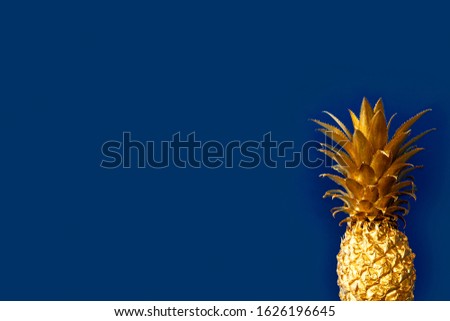 Top view, Golden pineapple fruit on classic blue background. Copy Space. Vertical photography