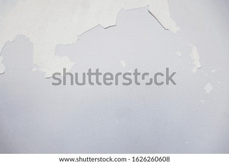 The old gray white Cement wall  Painted in white  is dirty Broken shabby  obsolete cracked, peeled, damaged    plaster mortar  abstract    textured  background close up.