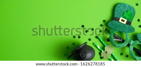 St. Patrick's Day header or banner design with pot of gold, St.Patrick's Day green glasses, drinking straws decorated shamrock leaf clover, confetti. Happy Saint Patricks Day concept