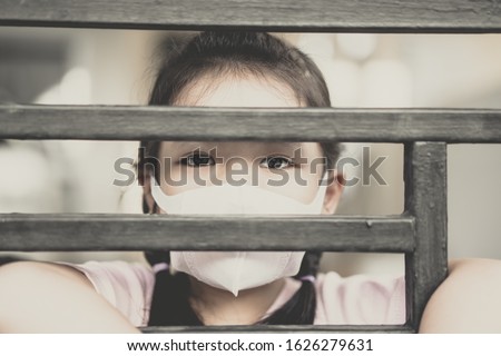 Coronavirus Covid-19.Stay at home Stay safe concept.Little chinese girl wearing mask for protect.Social distancing isolation for stop coronavirus.Coronavirus pandemic virus symptoms.Home school kid. Royalty-Free Stock Photo #1626279631