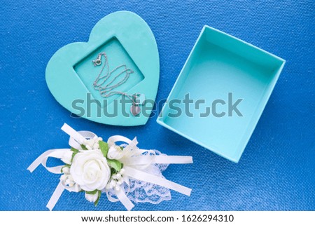romantic composition. open empty gift box, envelope and women's accessories