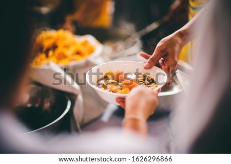 Food donation to hungry people, poor hands waiting to receive free food from volunteers Royalty-Free Stock Photo #1626296866