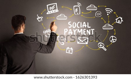 businessman drawing social media icons with SOCIAL PAYMENT inscription, new media concept