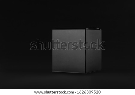Elegant black paper cube box on dark black background, side view, mock up of packing for product, advertising, presentation, design.