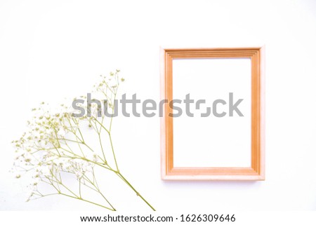 Frame for text with white flowers on a white table.  Top view, copy space.
