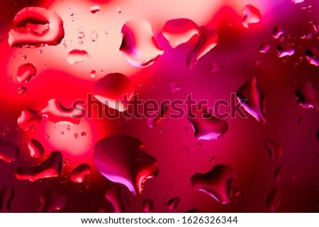 Large drops of water on the glass. Pink, red are the colors of love. Macro mode. Background. Copy space.