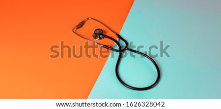 stethoscope on a bright bicolor background, panorama banner