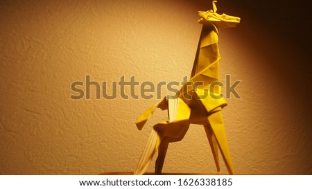 Giraffe folded on a piece of paper