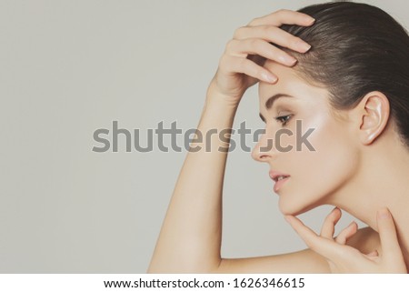 Young healthy woman face close up. Beautiful girl head studio portrait
