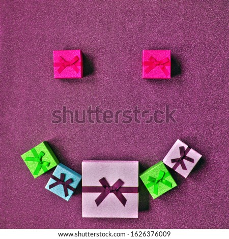  Holiday gifts concept. Smiley symbol formed from gift boxes.