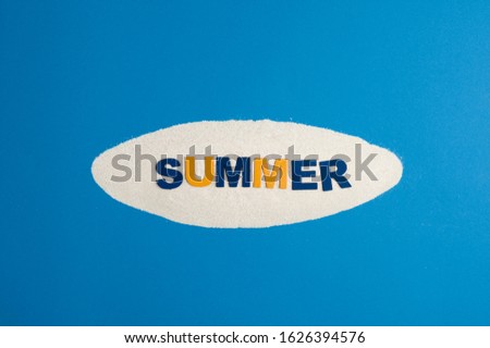 Pile of yellow sand isolated with word summer written with orange and blue letters on white background.