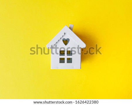 house models on yellow background.
