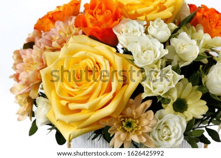 box of flowers, close-up with blurred background, large yellow rose, yellow chrysanthemum, pink chrysanthemum, white rose, orange rose as a background for the designer