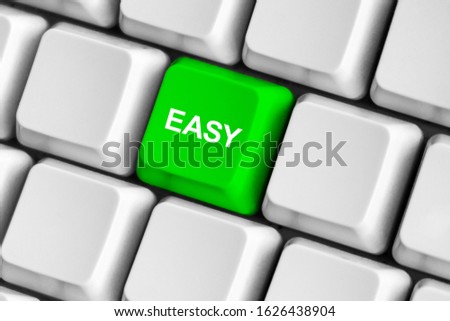 Green "easy" button on the white computer keyboard.