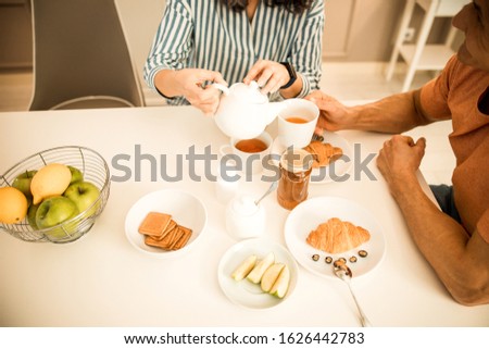 Top view of adult couple having breakfast while enjoying tea stock photo