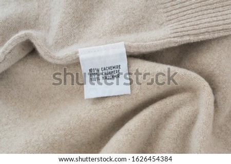 100 % cashmere label on cashmere background Royalty-Free Stock Photo #1626454384